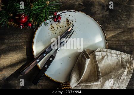Minimalistic table setting for Christmas dinner on wooden table Stock Photo
