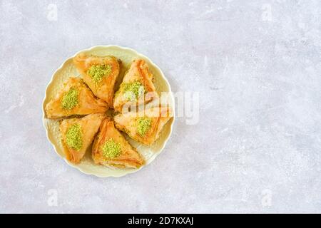 Sweets arabic dessert baklava, , kunafa, kadayif with pistachio and cheese . Top view, copy space Stock Photo