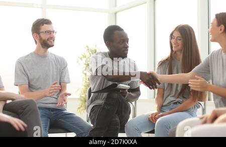 group of young people greeted the speaker with their applause Stock Photo