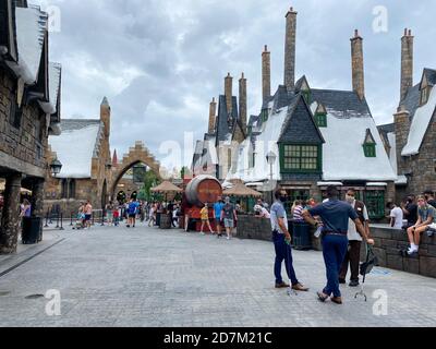 Orlando, FL/USA - 10/18/20:  The exterior of the Hogsmeade a Harry Potter themed area at Universal Studios in Orlando, Florida with people wearing fac Stock Photo