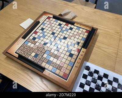 Orlando,FL/USA-10/20/20: A wooden  Scrabble game board, by Hasbro, on a wooden table. Stock Photo