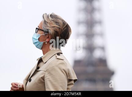 Paris, France. 23rd Oct, 2020. A woman wearing a face mask walks past the Trocadero Place near the Eiffel Tower in Paris, France, Oct. 23, 2020. With a record 42,032 new infections confirmed in the last 24 hours, France has counted an accumulative total of 1,041,075 COVID-19 cases as of Friday, becoming the second European Union (EU) country passing the grim one-million mark after Spain. Credit: Gao Jing/Xinhua/Alamy Live News Stock Photo