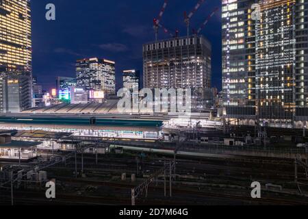 Train tracks in Tokyo Station after sunset.