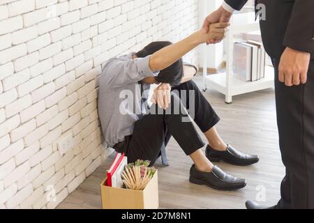 The hand of the man helping the unemployed Asian man feels frustrated and despair. Stock Photo