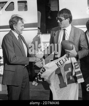 Buffalo Bills quarterback Jim Kelly, right, is greeted by Bills owner Ralph  Wilson, Jr. with a football and a jersey as he came off a private plane in  Buffalo, New York on