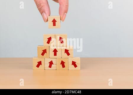 Hand arranging wood block with arrow up icon. Business concept growth ...