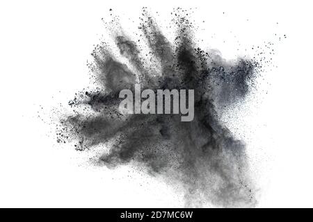 Black powder explosion against white background.The particles of charcoal splattered on white background. Stock Photo