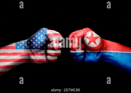 conflict between USA vs Korea north, male fists - governments conflict concept, Flags written on hands USA, USA Flag, USA counter, fists symbol war Stock Photo