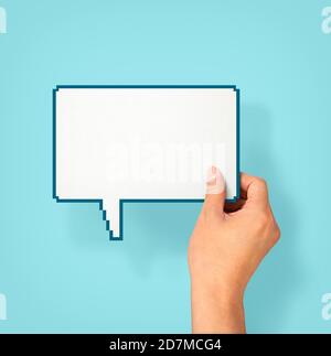 Two hands holding up speech bubbles Stock Photo