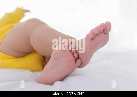 The baby's feet are sleeping in the bed. Stock Photo