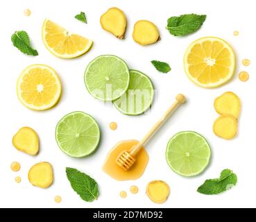 composition of honey spoon, ginger and citrus fruit slices isolated on white background, top view Stock Photo
