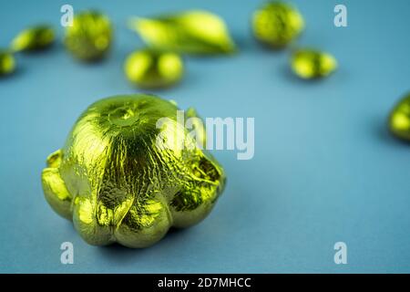 Pumpkins, nuts and leaves painted in gold on a blue background. Flat layout with space for text. Selective focus Stock Photo