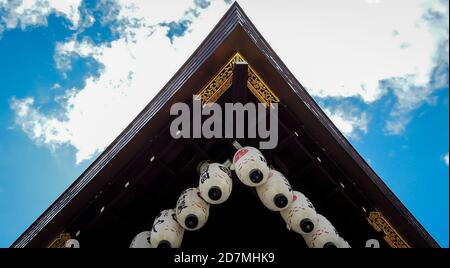 Japanese temple shrine shinto corner with lanterns hanging and gold details on a wooden structure in kyoto japan luxury travel adventure clouds Stock Photo