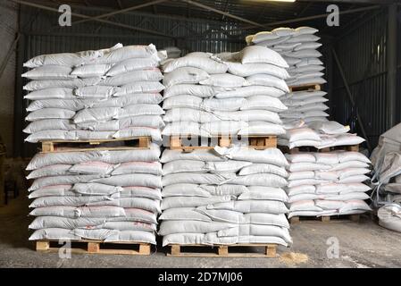 STARIY OSKOL, RUSSIA - FEBRUARY 19, 2020: many filled bags on pallets in the warehouse Stock Photo