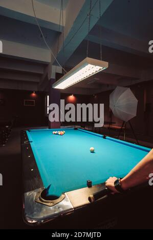 Vertical shot of a blue billiard table under lights Stock Photo