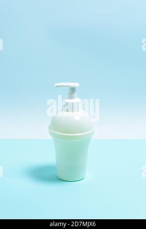 white soap bottle on a blue and white background. the view from the top. Stock Photo