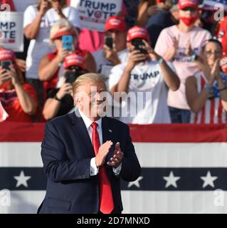President Donald Trump claps after First Lady Melania Trump concluded ...