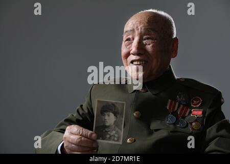 (201024) -- BEIJING, Oct. 24, 2020 (Xinhua) -- Wang Renshan, veteran of the Chinese People's Volunteers (CPV), shows an old photo of himself in Beijing, capital of China, Oct. 13, 2020. Wang was born in 1928. He entered the Democratic People's Republic of Korea (DPRK) to fight in the War to Resist U.S. Aggression and Aid Korea with the CPV army in 1950.  On Oct. 19, 1950, as requested by the DPRK, CPV forces crossed the Yalu River to aid the DPRK's fight there until a truce was signed in 1953. A total of 2.9 million CPV soldiers entered the battlefield.   Photographers from Xinhua took portrai Stock Photo