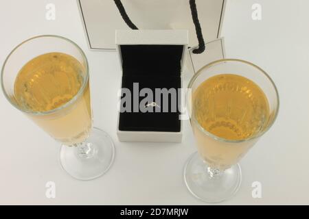 Two glasses of champagne and an engagement ring. The proposal preparation concept Stock Photo