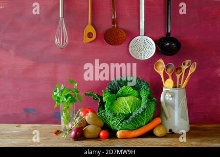 Fresh cabbage,various vegetables,kitchen utensils,food ingredients, cooking concept, free copy space Stock Photo