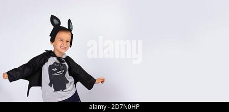 Cute bat smiling is preparing for Halloween, photo on a white background with plenty space. Banner- long format Stock Photo