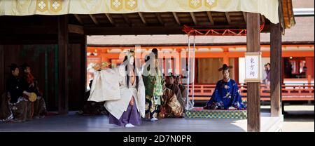 Nô actors performing on scene at Itsukushima Shrine on Miyajima island, Hiroshima Ken, Seto Inland Sea, Japan 2012. Stock Photo