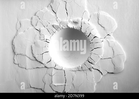 A crater on white powder background. Round crater with cracks. Stock Photo