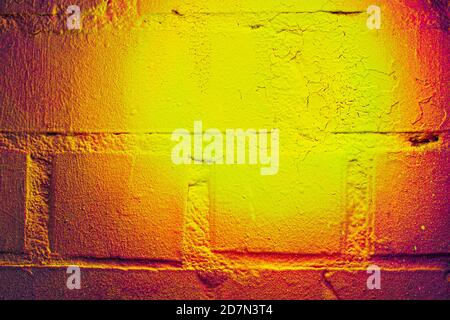 A fragment of colorful graffiti painted on a brick wall. Abstract background for design. Stock Photo