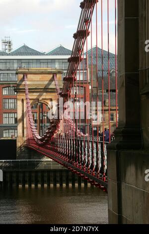 Glasgow, Scotland, UK.. Bridges over the River Clyde at night time. The South Portland Street Suspension Bridge is a suspension type foot bridge for pedestrians to cross the River Clyde. Built between 1851 and 1853, it's about 4 metres wide and 127 metres long, replacing the old wooden bridge. It's a nice way to get across the river from the southern end of Glasgow City Centre to the south side Carlton with it's cobbled stone pavement and Georgian terraced houses. Stock Photo