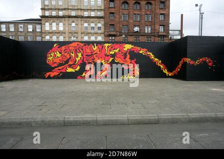 Glasgow, Clydeside, Scotland, UK. A large mural of a tiger painted on riverside wall along side the River Clyde, The mural painting was commissioned by a company called Tiger Beer in collaboration with artists. Different art work representing the elements of the Chinese Zodiac , water, earth, wood, fire and metal. This mural depicting fire was designed and produced McFaul Studio, whose creative director John McFaul hail from Glasgow Stock Photo