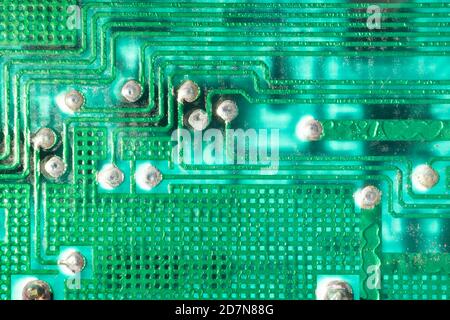 Electronic printed circuit board background with many electrical components, hardware. Green color Stock Photo