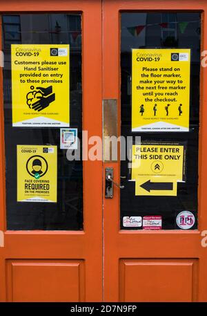 Listowel, Ireland - 24th October 2020:  Social distancing and cleaning etiquette on door of business  during 2nd nationwide lockdown due to covid-19 p Stock Photo