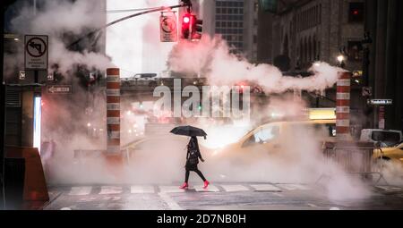 A woman wearing red high heels is crossing the 42nd street in Manhattan during the Covid-19 outbreak. Manhattan, New York City, United States. Stock Photo