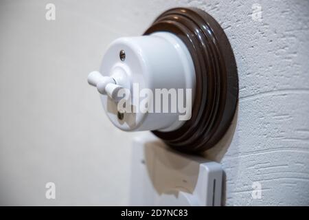 retro electric switch on the wall Stock Photo
