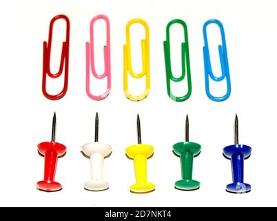 Push pins and paper clips in different colors isolated on white background. Stock Photo