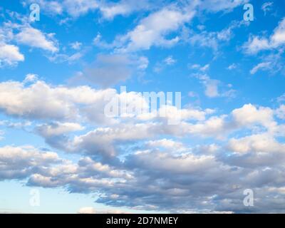 many low clouds in blue sky on sunny autumn day Stock Photo