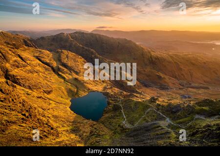 Sunrise seen from top of Lake District mountain; The Old Man of Coniston. Stock Photo