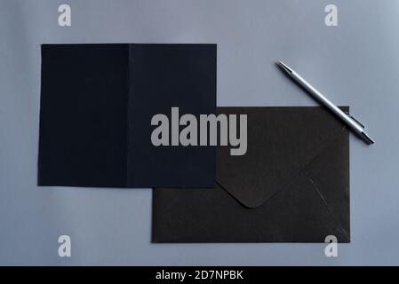 Opened bifold mock-up white template paper brochures and envelope on a black background, copy space. Stock Photo