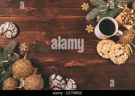 Flat lay composition with christmas decorations, gifts, cup of coffee and cookies on brown wooden table. Stock Photo