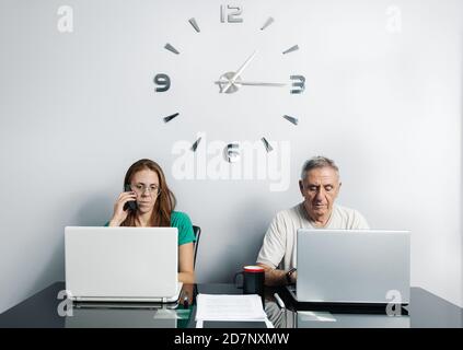 Mature couple teleworking in home office Stock Photo