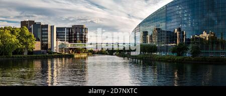 Panoramic view of the European Parliament in Strasbourg with reflection in the river Ill, France