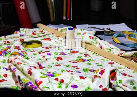 Printed fabric with flowers and sewing accessories Stock Photo