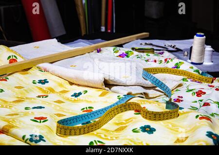 Various fabrics in yellow and beige colors with meter and ruler Stock Photo