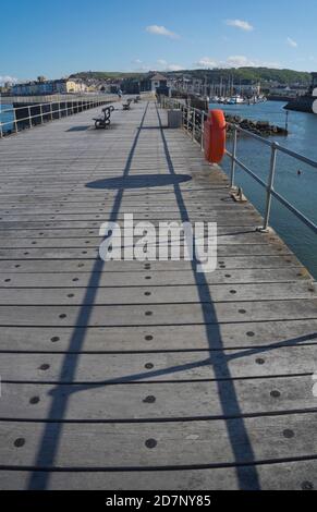 Empty pier by the harbour and lighthouse at Aberystwyth,Ceredigion,Wales,UK Stock Photo
