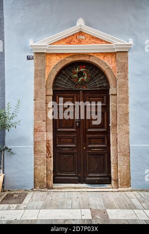 Ancient wooden door with ornaments, found in Nafplio, Greece Stock Photo