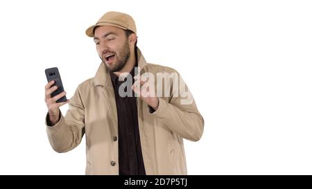 Blogger in trench with recording video on his phone while walkin Stock Photo