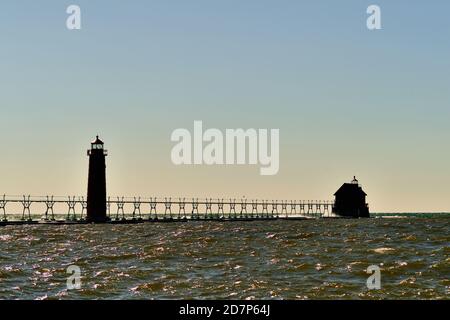 Grand Haven, Michigan, USA. The Grand Haven South Pierhead Inner Light, left, is the inner light of two lighthouses on the south pier of Grand Haven. Stock Photo