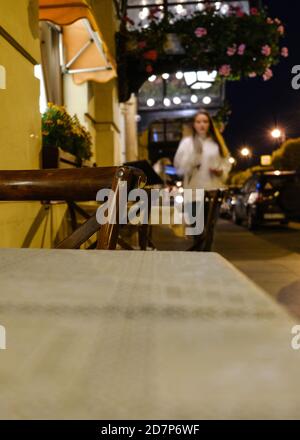 Background, blur, out of focus, bokeh. Night cafe. Abstract night city blurred by the rays of lanterns for decoration. Yellow background. Abstract background Stock Photo