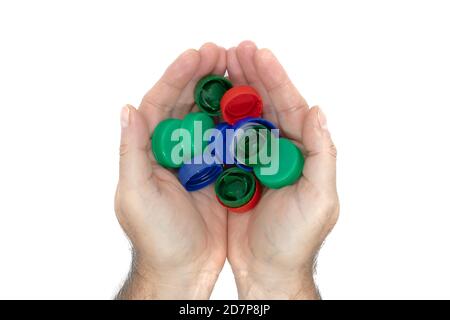 hands holding plastic bottles caps for recycling, environment conservation concept, isolated on white background Stock Photo