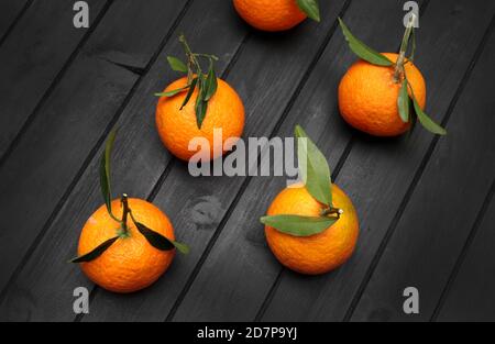 Mandarins fruit isolated on dark background. Top view. Stock Photo